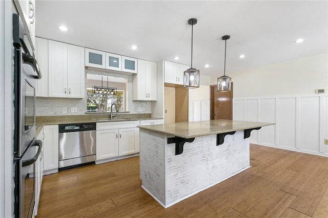 kitchen featuring white cabinetry, a center island, and stainless steel appliances