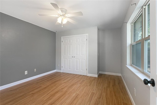 unfurnished bedroom with a closet, ceiling fan, and light hardwood / wood-style floors