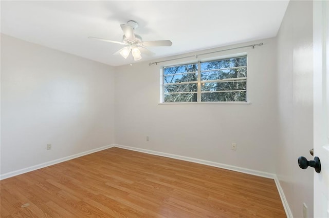 empty room with ceiling fan and light hardwood / wood-style floors