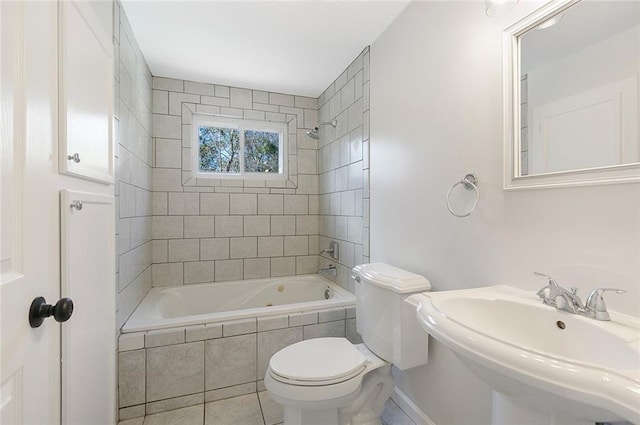 full bathroom featuring tile patterned flooring, tiled shower / bath combo, toilet, and sink