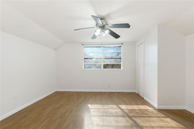 additional living space featuring hardwood / wood-style flooring, ceiling fan, and lofted ceiling