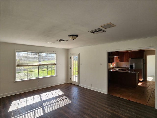 spare room featuring dark wood-type flooring