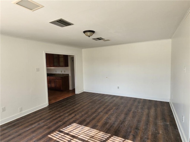 spare room featuring dark hardwood / wood-style floors