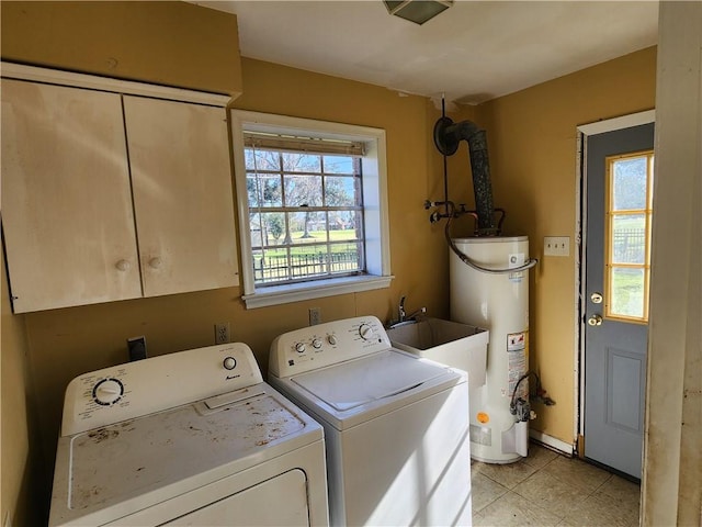 laundry room featuring washer and dryer, gas water heater, and cabinets