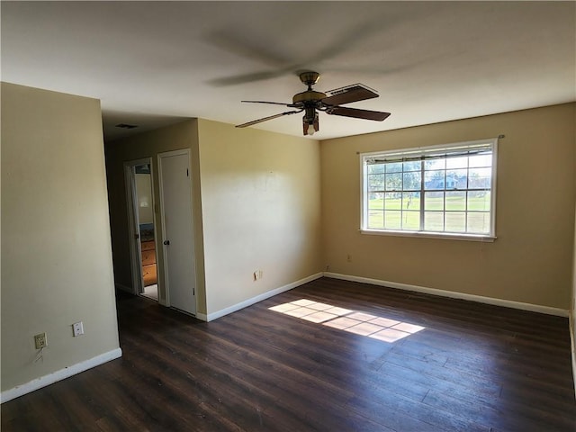 empty room featuring dark hardwood / wood-style floors and ceiling fan