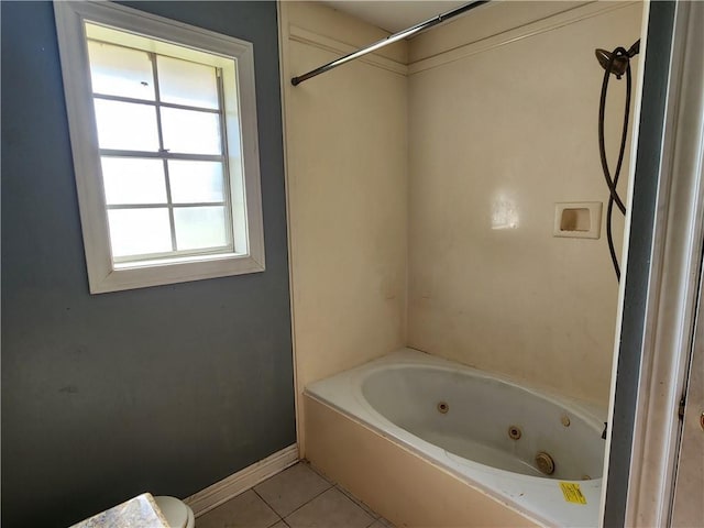 bathroom featuring toilet, tile patterned flooring, and tub / shower combination