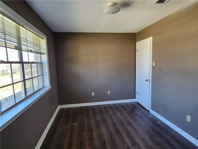 unfurnished room featuring dark hardwood / wood-style flooring