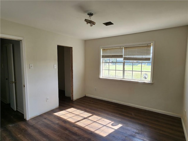 unfurnished bedroom featuring dark hardwood / wood-style flooring