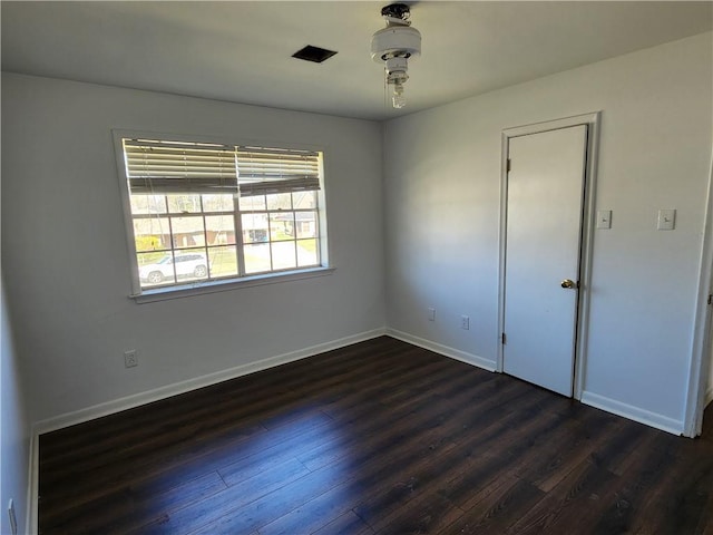 empty room with dark wood-type flooring