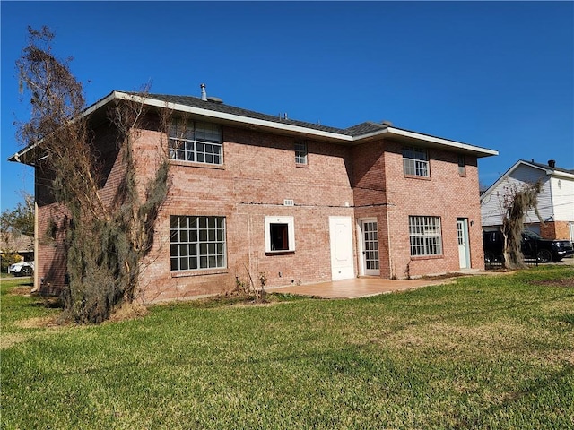 back of property featuring a lawn and a patio area