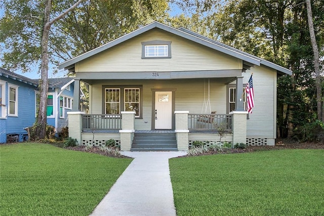 view of front of home with a front yard and covered porch