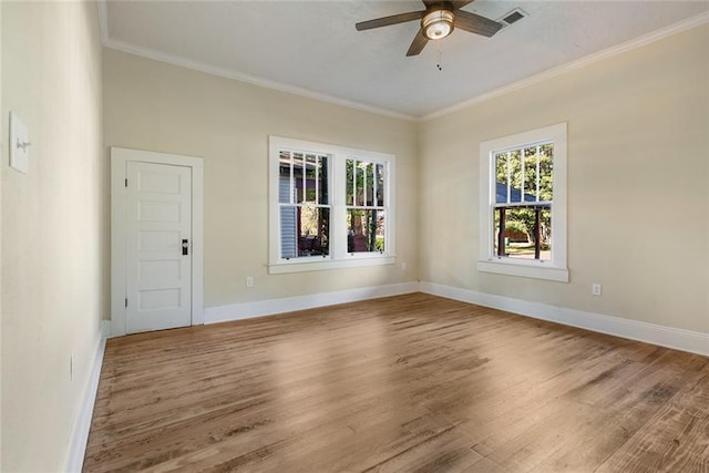 spare room featuring hardwood / wood-style flooring, ornamental molding, and ceiling fan