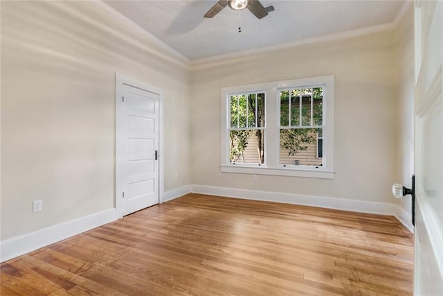 spare room featuring wood-type flooring, ornamental molding, and ceiling fan