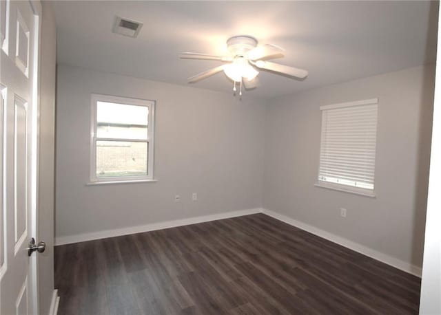 empty room featuring dark hardwood / wood-style floors and ceiling fan