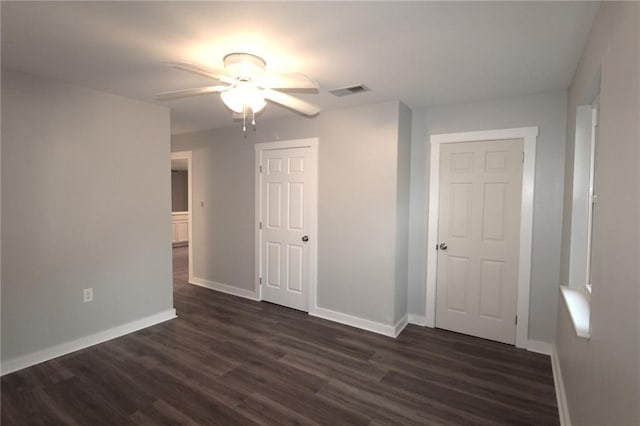 spare room featuring ceiling fan and dark hardwood / wood-style flooring