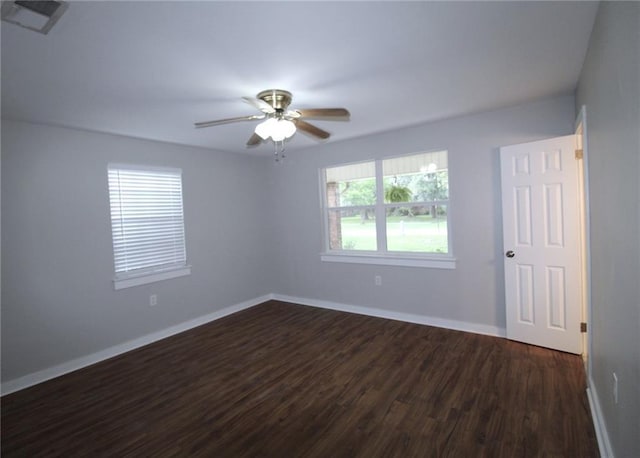 spare room featuring dark hardwood / wood-style floors and ceiling fan