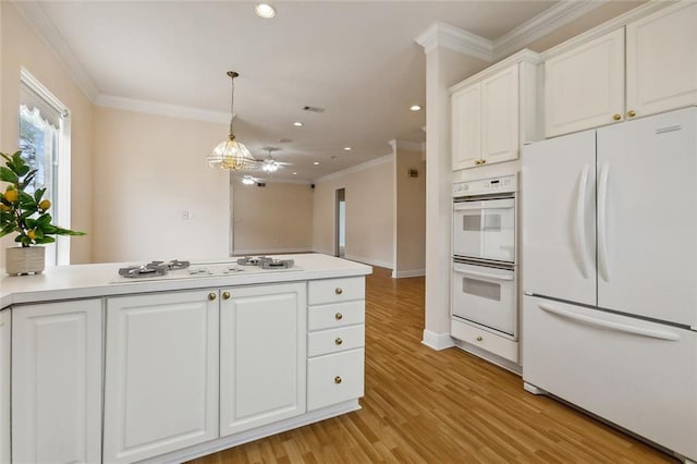 kitchen featuring white appliances, ceiling fan, decorative light fixtures, white cabinets, and light hardwood / wood-style floors