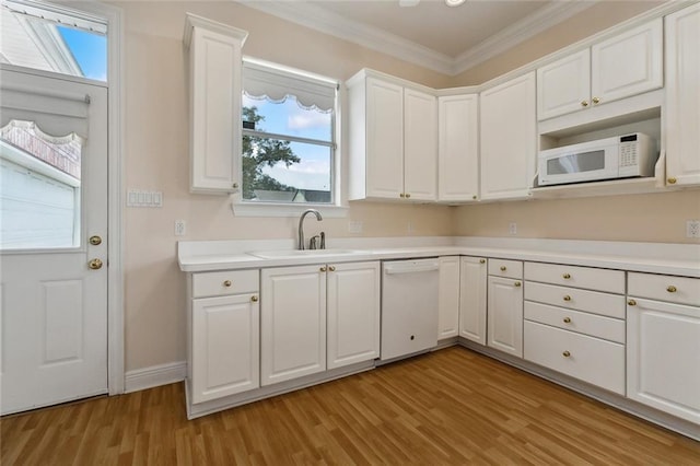 kitchen with white appliances, light hardwood / wood-style floors, white cabinetry, and sink