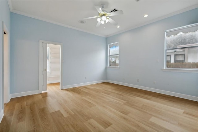 unfurnished bedroom with ceiling fan, crown molding, light hardwood / wood-style flooring, a spacious closet, and a closet