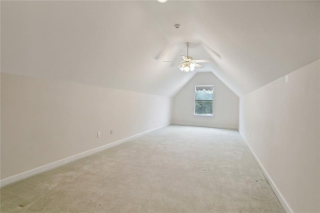 additional living space featuring light colored carpet, ceiling fan, and lofted ceiling