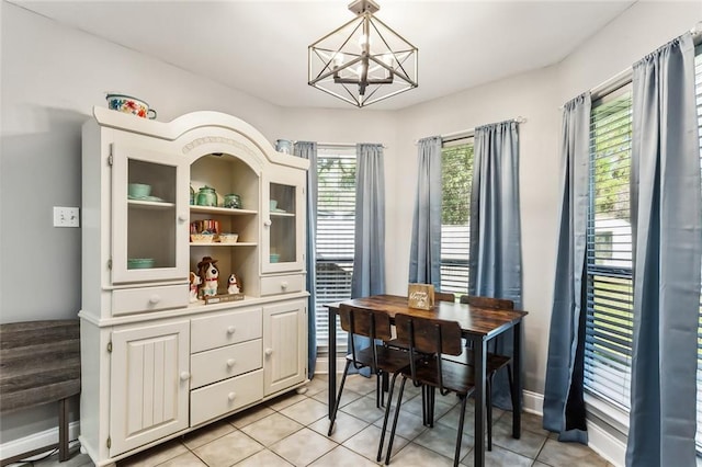 tiled dining area featuring an inviting chandelier