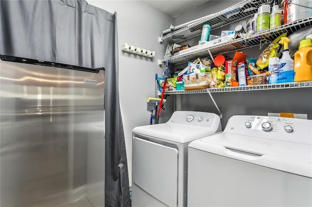 clothes washing area featuring separate washer and dryer