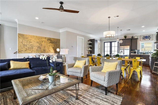 living room with ornamental molding, dark hardwood / wood-style floors, and ceiling fan