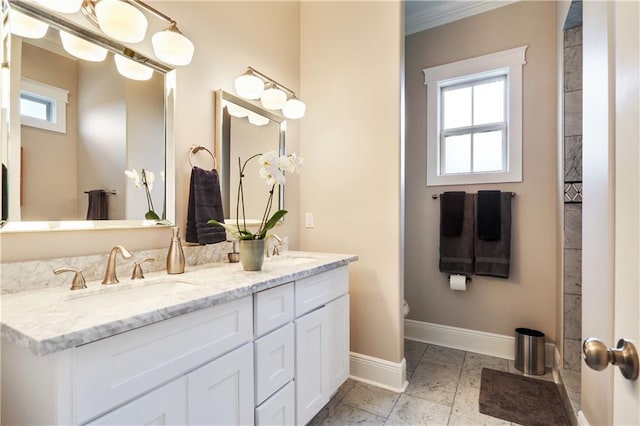 bathroom featuring ornamental molding and vanity