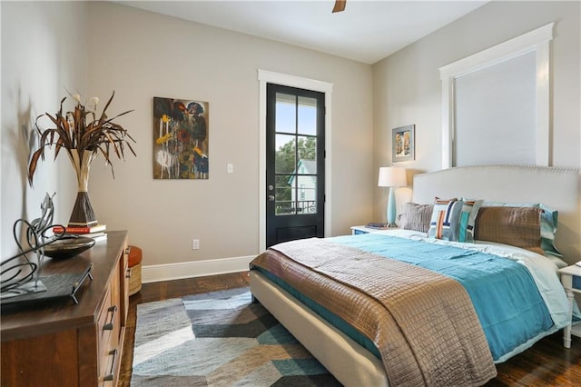 bedroom with ceiling fan, dark hardwood / wood-style floors, and access to outside