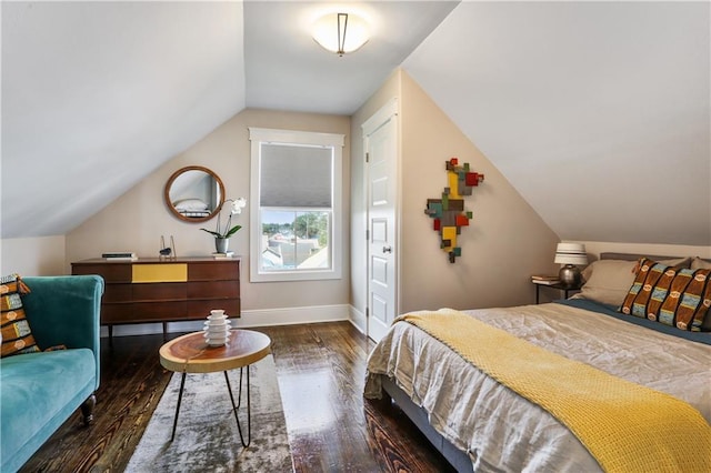 bedroom featuring dark wood-type flooring and vaulted ceiling