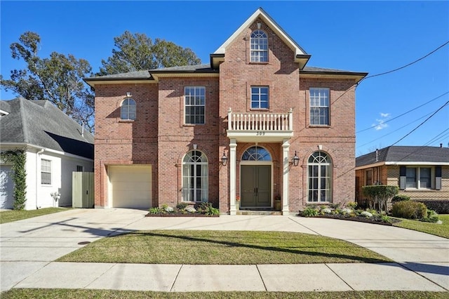 front of property featuring a balcony and a garage