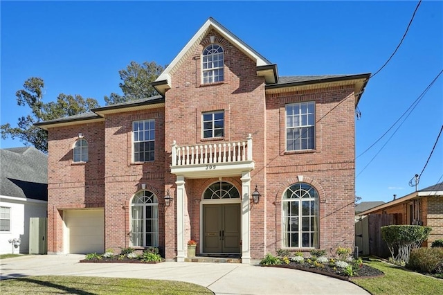 view of property with a balcony and a garage