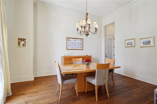 dining room featuring crown molding, hardwood / wood-style floors, and a chandelier