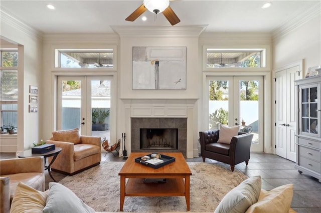 living room with a fireplace, french doors, and plenty of natural light