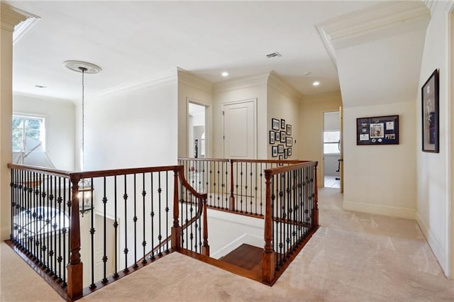 corridor featuring ornamental molding, light carpet, and a chandelier