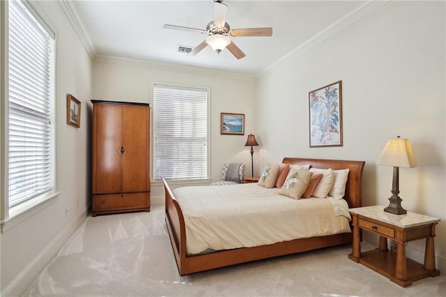 bedroom featuring multiple windows, light colored carpet, ceiling fan, and ornamental molding