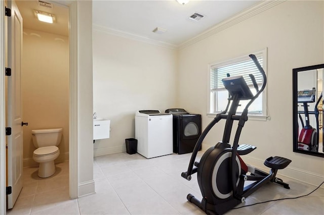 workout room with washer and dryer, light tile patterned floors, and crown molding