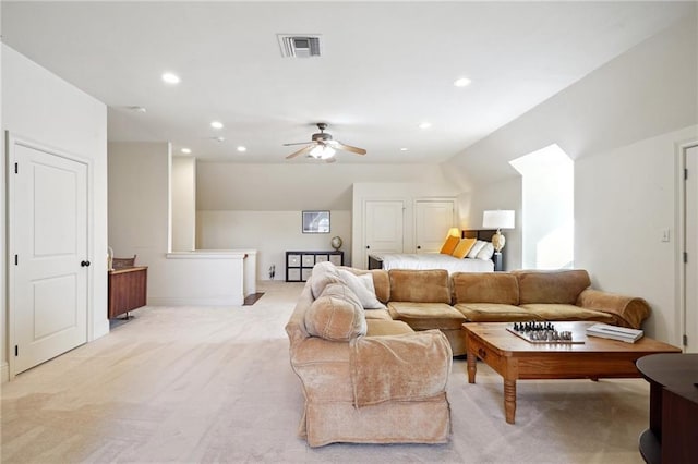 carpeted living room featuring ceiling fan and lofted ceiling