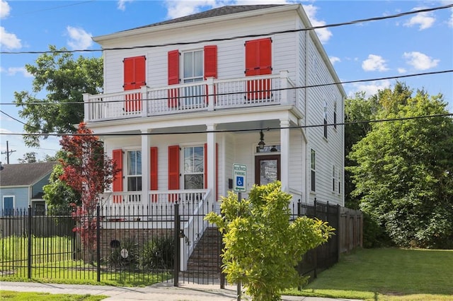 view of front of home featuring a balcony and a front lawn