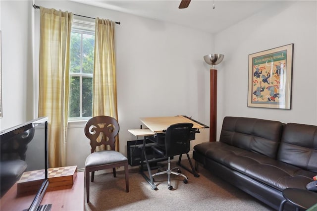 carpeted office featuring ceiling fan