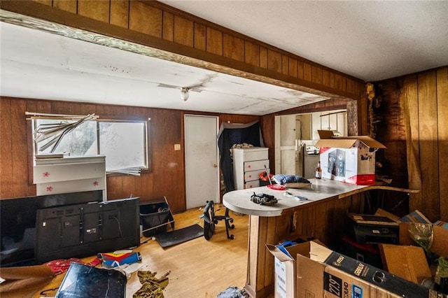 interior space with hardwood / wood-style floors and wooden walls