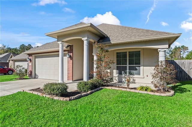 view of front of house featuring a garage and a front lawn