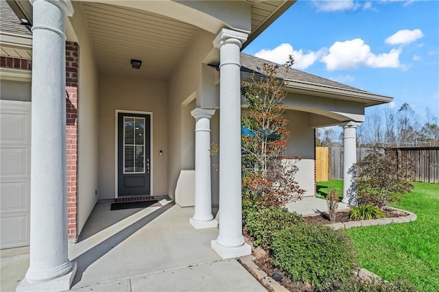 entrance to property featuring a porch and a garage