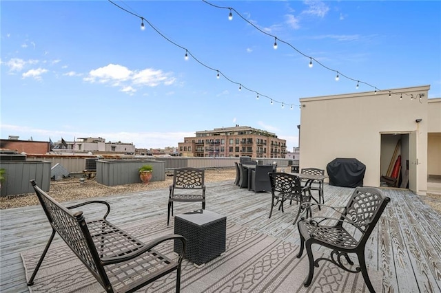 deck featuring a grill and a jacuzzi