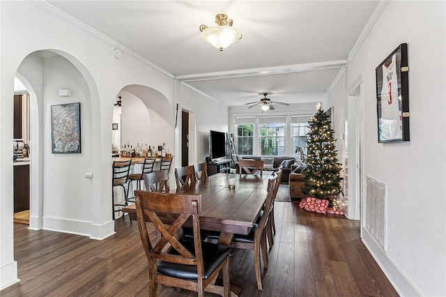 dining room featuring ceiling fan, dark hardwood / wood-style flooring, and crown molding