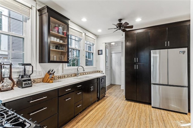 kitchen featuring stainless steel fridge, dark brown cabinetry, ceiling fan, sink, and light hardwood / wood-style floors