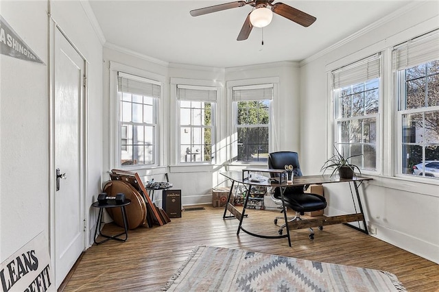 home office featuring hardwood / wood-style flooring, ceiling fan, and crown molding