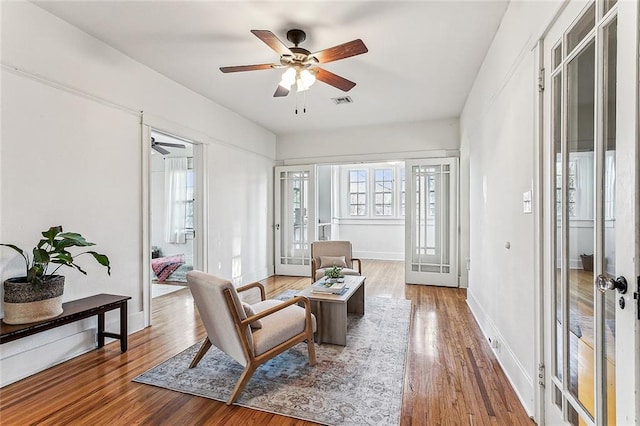 sitting room with french doors and hardwood / wood-style floors