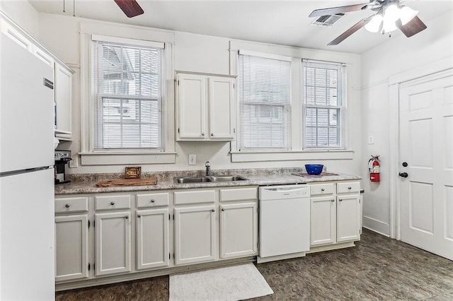 kitchen with sink, white cabinets, and white appliances