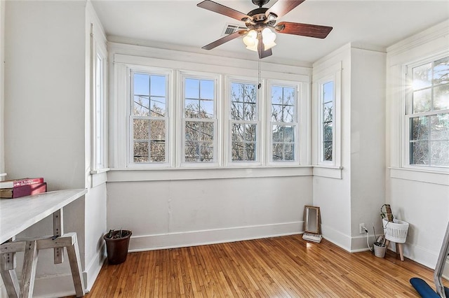 sunroom featuring ceiling fan